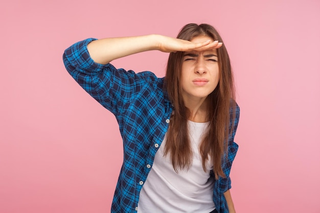 Portrait of beautiful young woman standing against wall