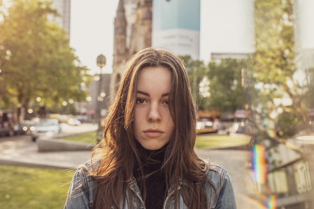 portrait of beautiful young woman standing in city