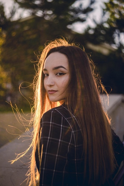 Portrait of beautiful young woman standing outdoors