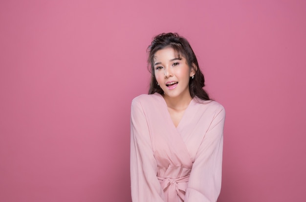 Portrait beautiful young woman in the studio on pink background