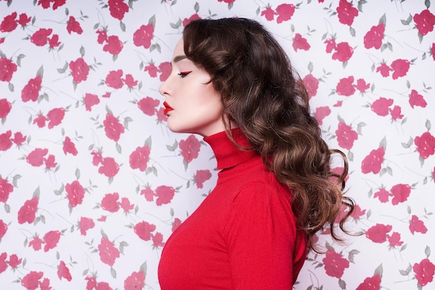 Portrait of a beautiful young woman surrounded by flowers