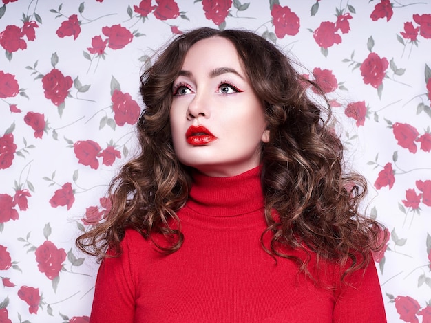 Portrait of a beautiful young woman surrounded by flowers