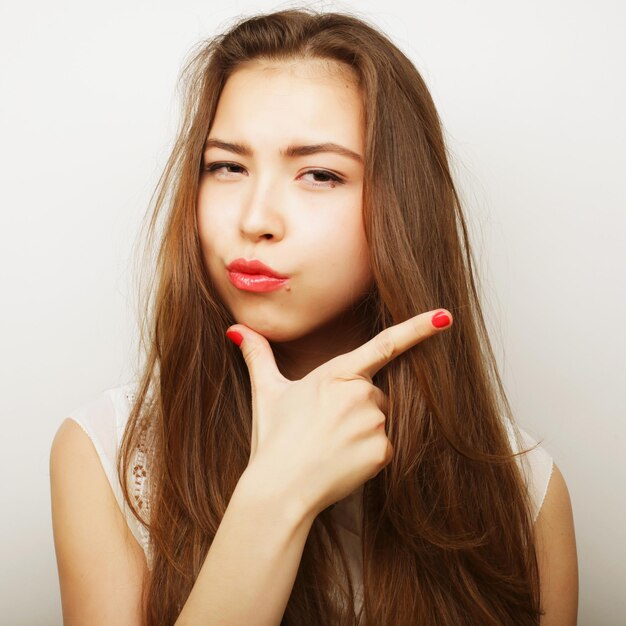 Portrait of a beautiful young woman thinking isolated on white background