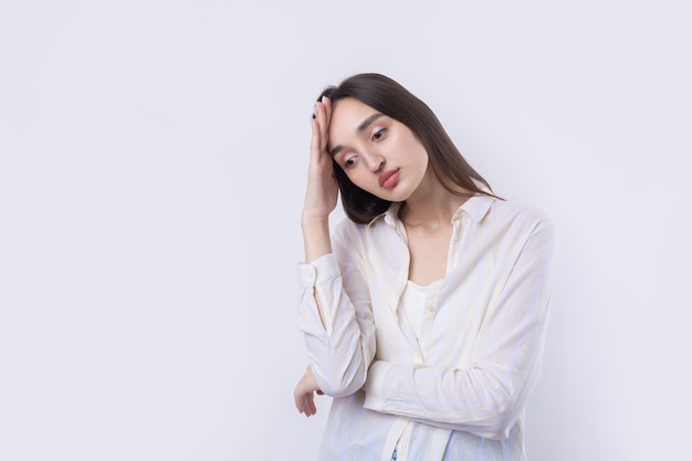 Portrait of a beautiful young woman thinking isolated on white background