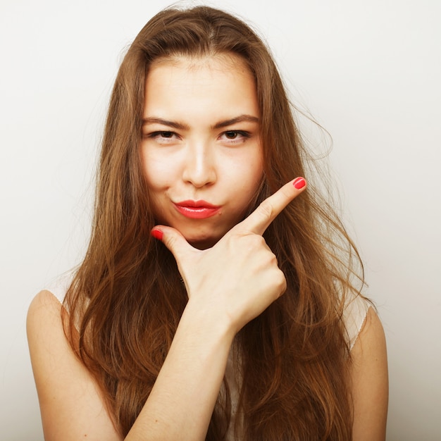 Portrait of a beautiful young woman thinking