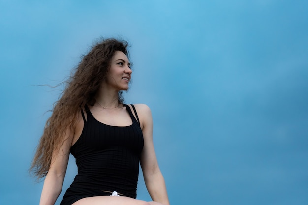 Portrait of beautiful young woman toothy smiling with happy face and joy emotion outdoor with blue sky