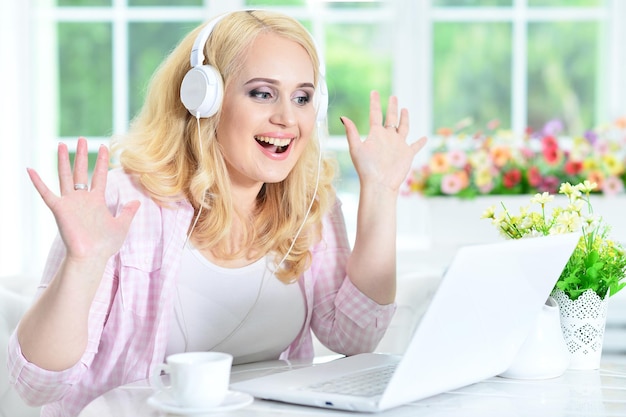 Portrait of a beautiful young woman using laptop indoors