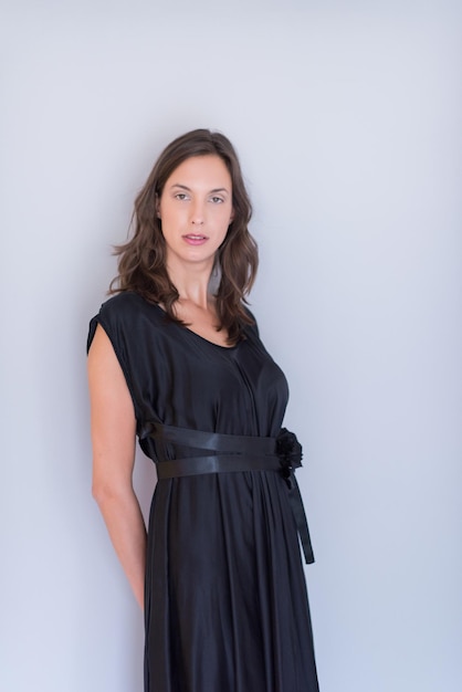 portrait of Beautiful young woman wearing a black dress isolated on white background