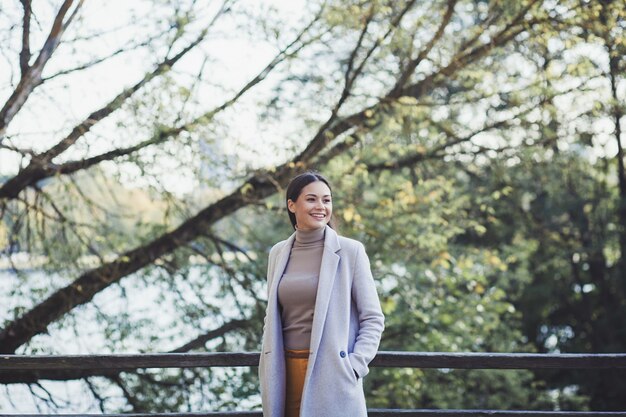 Portrait of a beautiful young woman wearing a coat outdoors