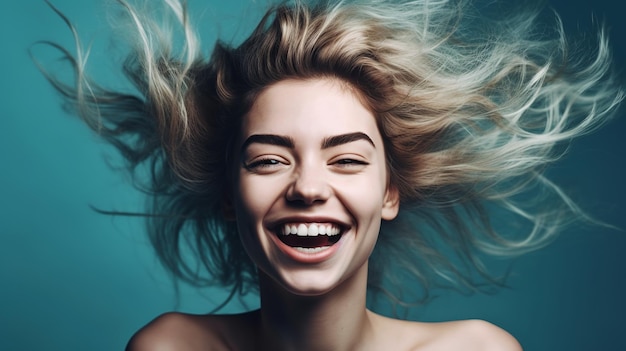 Portrait of a beautiful young woman with flying hair over blue background