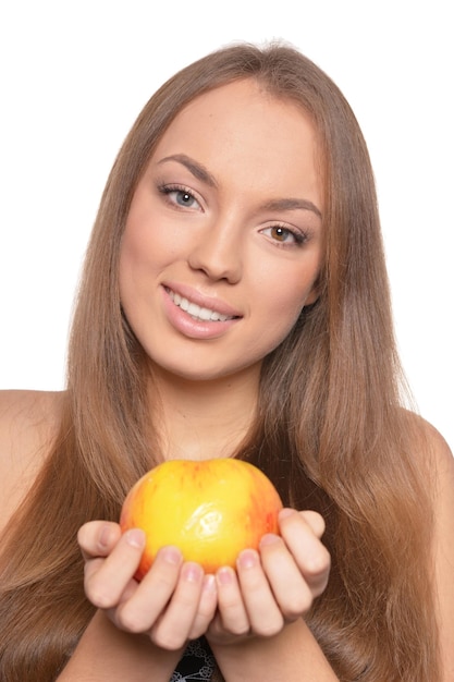 Portrait of beautiful young woman with ripe apple