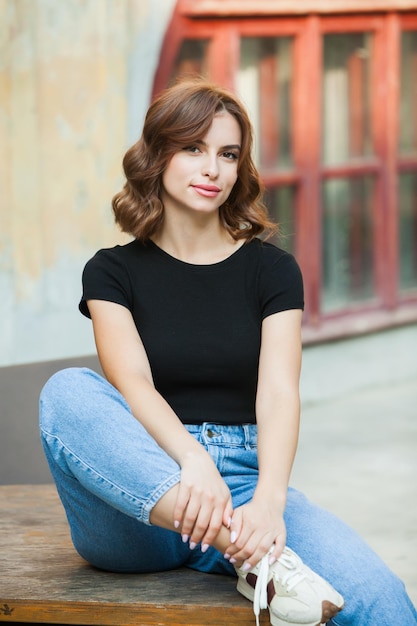 Portrait of a beautiful young woman with a smile on her face young brunette woman in white tshirt