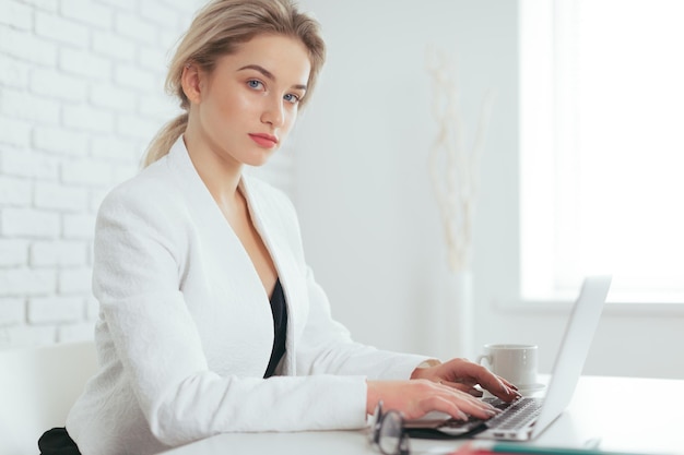 Portrait of beautiful young woman working in the office