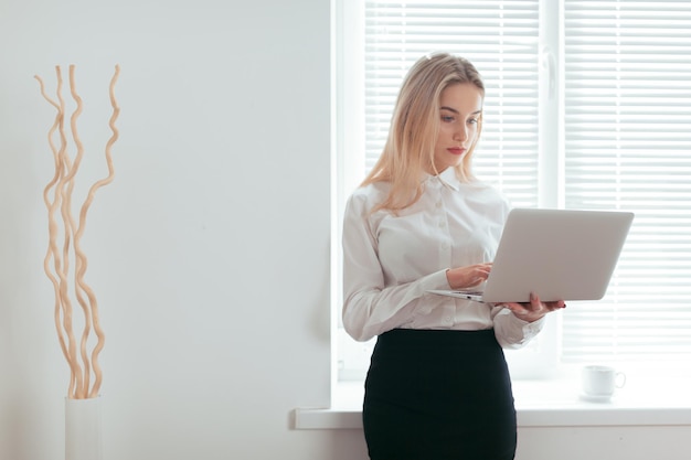 Portrait of beautiful young woman working in the office