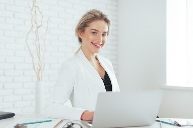 Portrait of beautiful young woman working in the office.