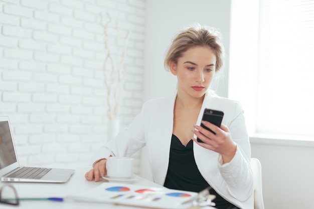 Portrait of beautiful young woman working in the office.