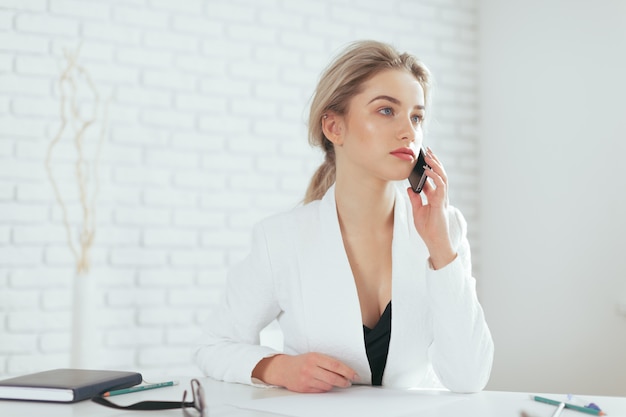 Portrait of beautiful young woman working in the office.