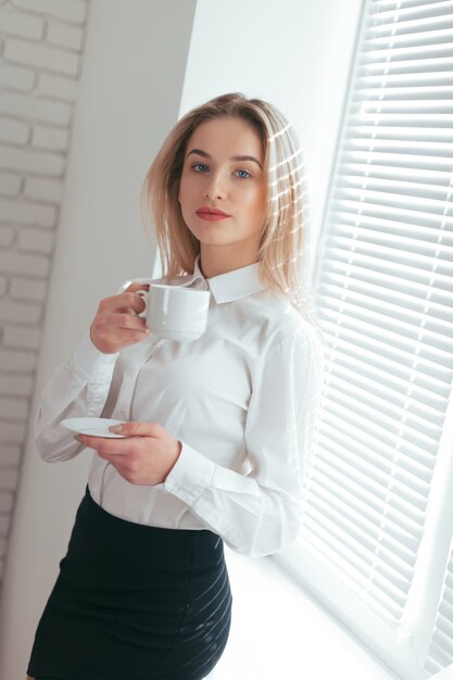 Portrait of beautiful young woman working in the office.