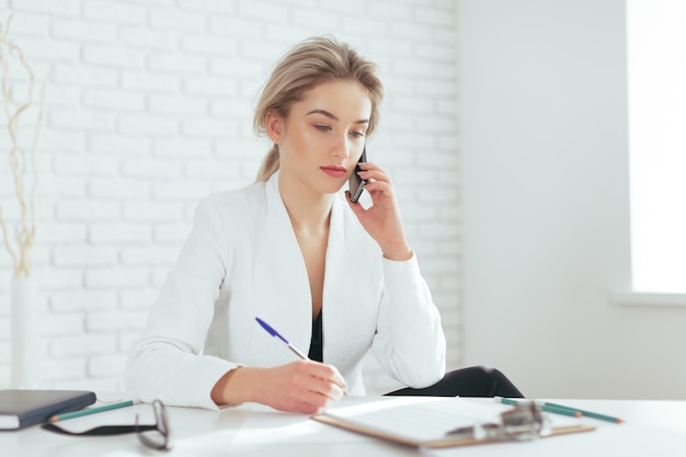 Portrait of beautiful young woman working in the office.