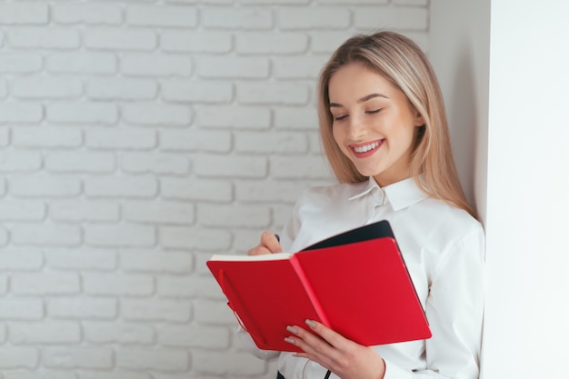 Portrait of beautiful young woman working in the office.