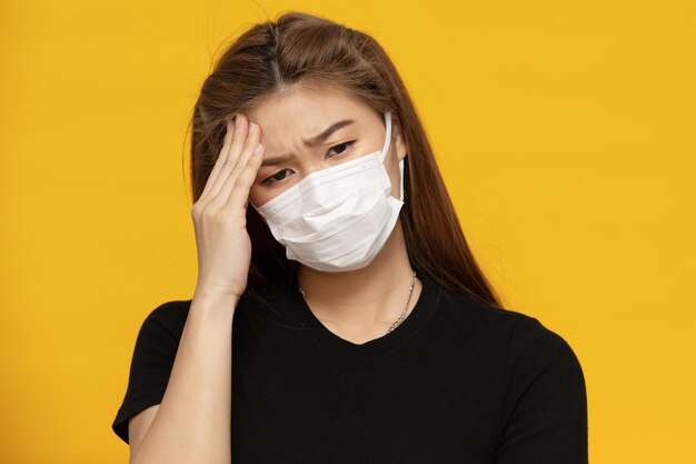 Portrait of a beautiful young woman over yellow background