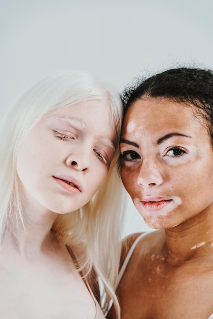 Portrait of beautiful young women against colored background