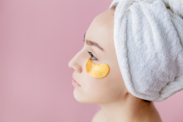 Portrait of Beauty Woman with Eye Patches on pink background