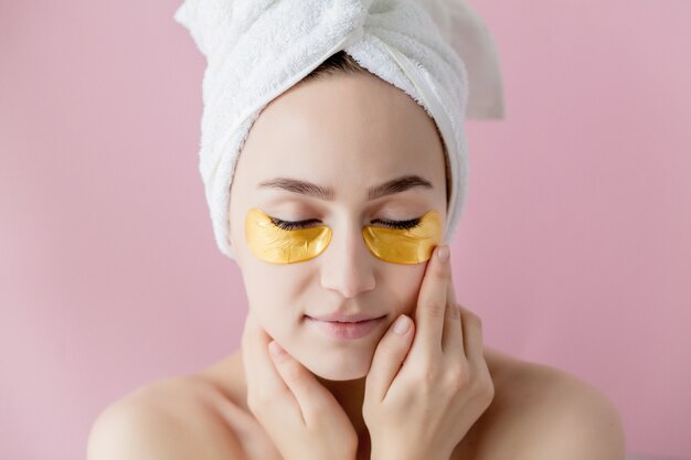 Portrait of Beauty Woman with Eye Patches on pink background.