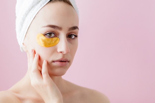 Portrait of Beauty Woman with Eye Patches on pink