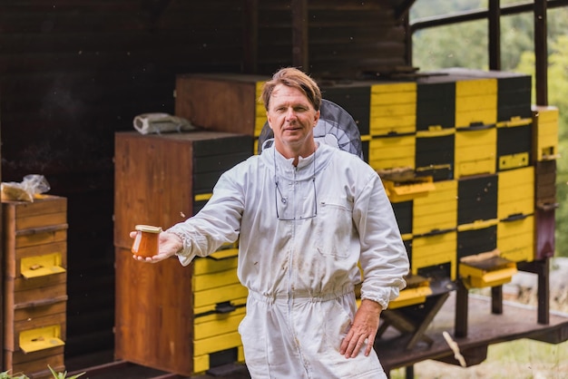 Portrait of beekeeper at beehive