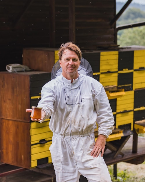 Portrait of beekeeper at beehive