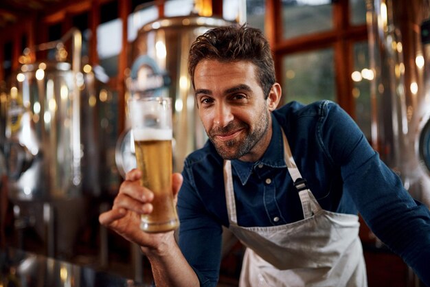 portrait beer and man brewer in factory for taste of alcohol for quality control production happy career and business owner with drink for fermentation in distillery for oktoberfest in munich