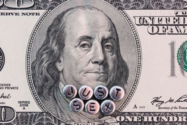 Premium Photo Portrait of benjamin franklin on the hundred dollar banknote with the inscription just sex made of silver beads image photo