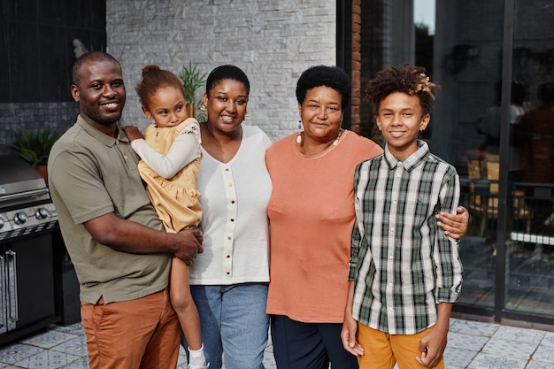 Portrait of big africanamerican family looking at camera while posing together at outdoor terrace an...