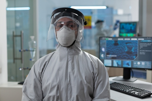 Portrait of biologist researcher in coronavirus protective medical equipment