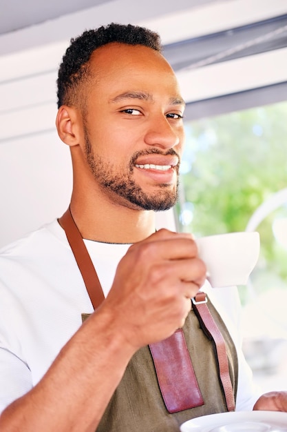 Portrait of Black bearded man drinks coffee.