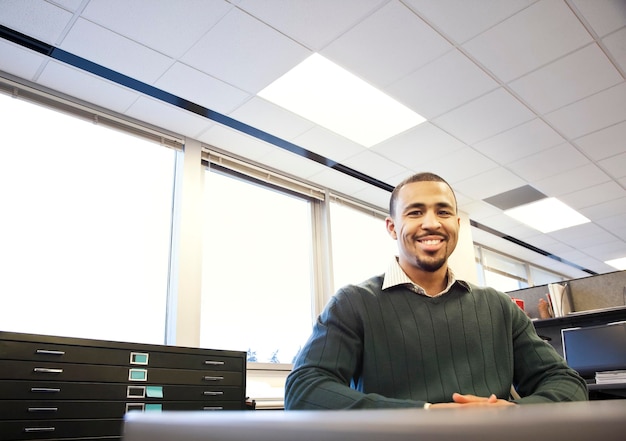 A portrait of a Black businessman in his corporate office