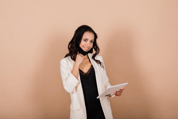 Portrait of black businesswoman wearing face mask during virus epidemic in a studio.