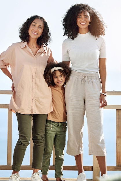 Portrait black family or children with a senior woman mother and daughter standing outdoor together on a balcony or veranda Mothers day love or kids with a girl parent and grandparent outside
