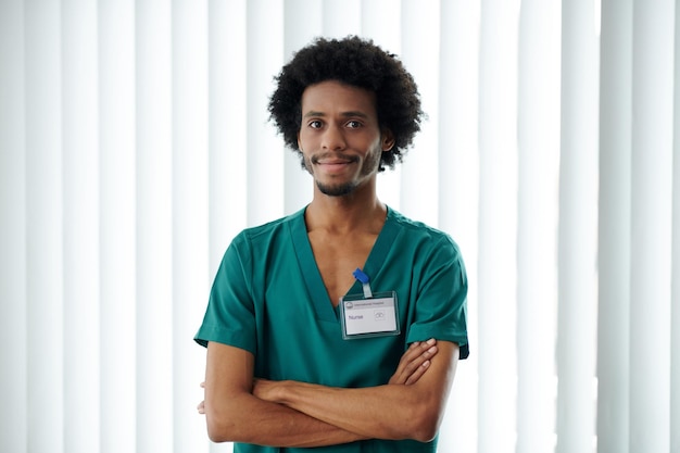 Portrait of Black male medical nurse crossing arms and looking at camera