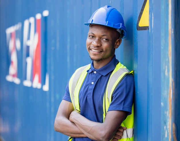 portrait black man engineering a helmet at container background 