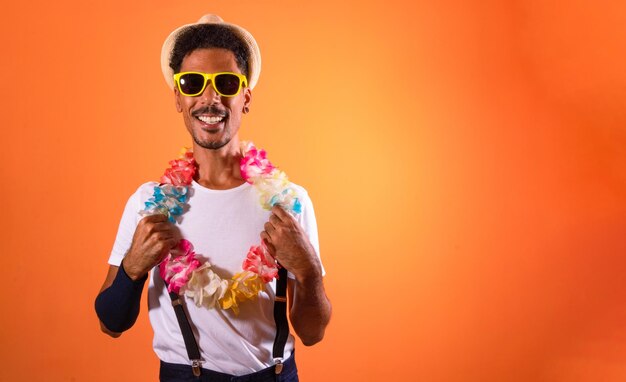 Portrait of Black Man With Carnival Props Isolated on Orange Background