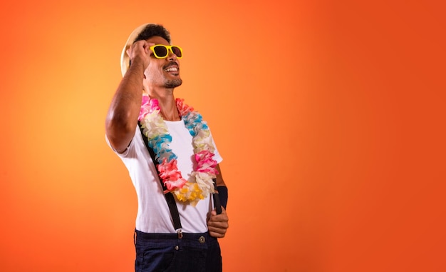 Portrait of Black Man With Carnival Props Isolated on Orange Background