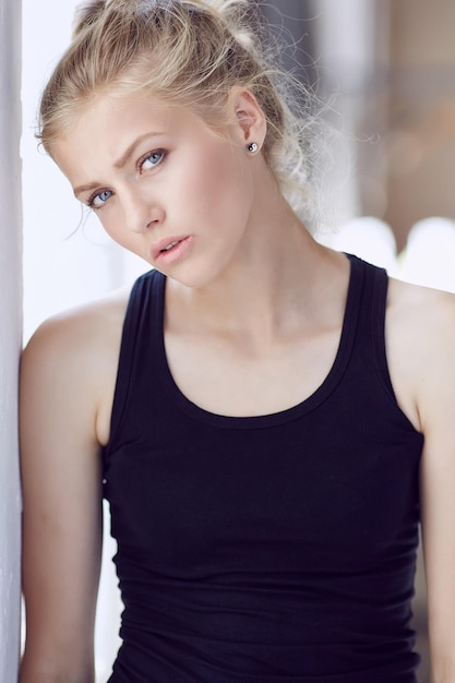 Portrait of blond woman in black shirt.