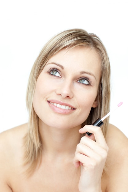 Portrait of a blond woman holding a lipstick