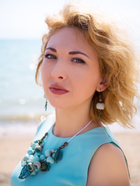 Portrait of blond woman wearing blue dress