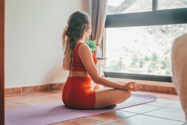 Portrait of blonde beautiful woman doing yoga and relaxing her mind and her body at home on the floor One active and heathy girl taking care of health training