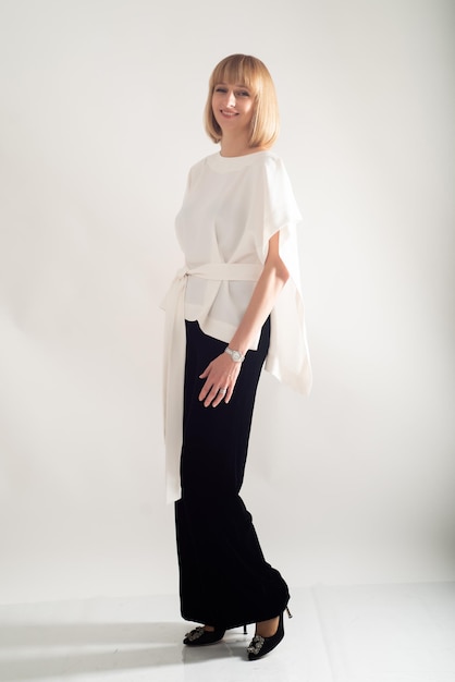 Portrait of blonde businesswoman confident on grey background