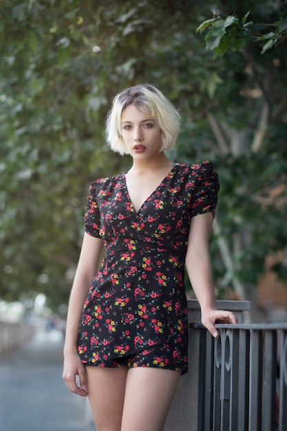 Portrait of a blonde girl in a city park