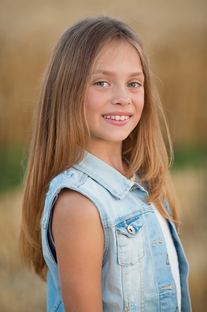 Portrait of a blonde girl. Golden hair, sun set